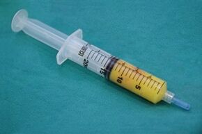 Syringe with adipose tissue for penis enlargement surgery.